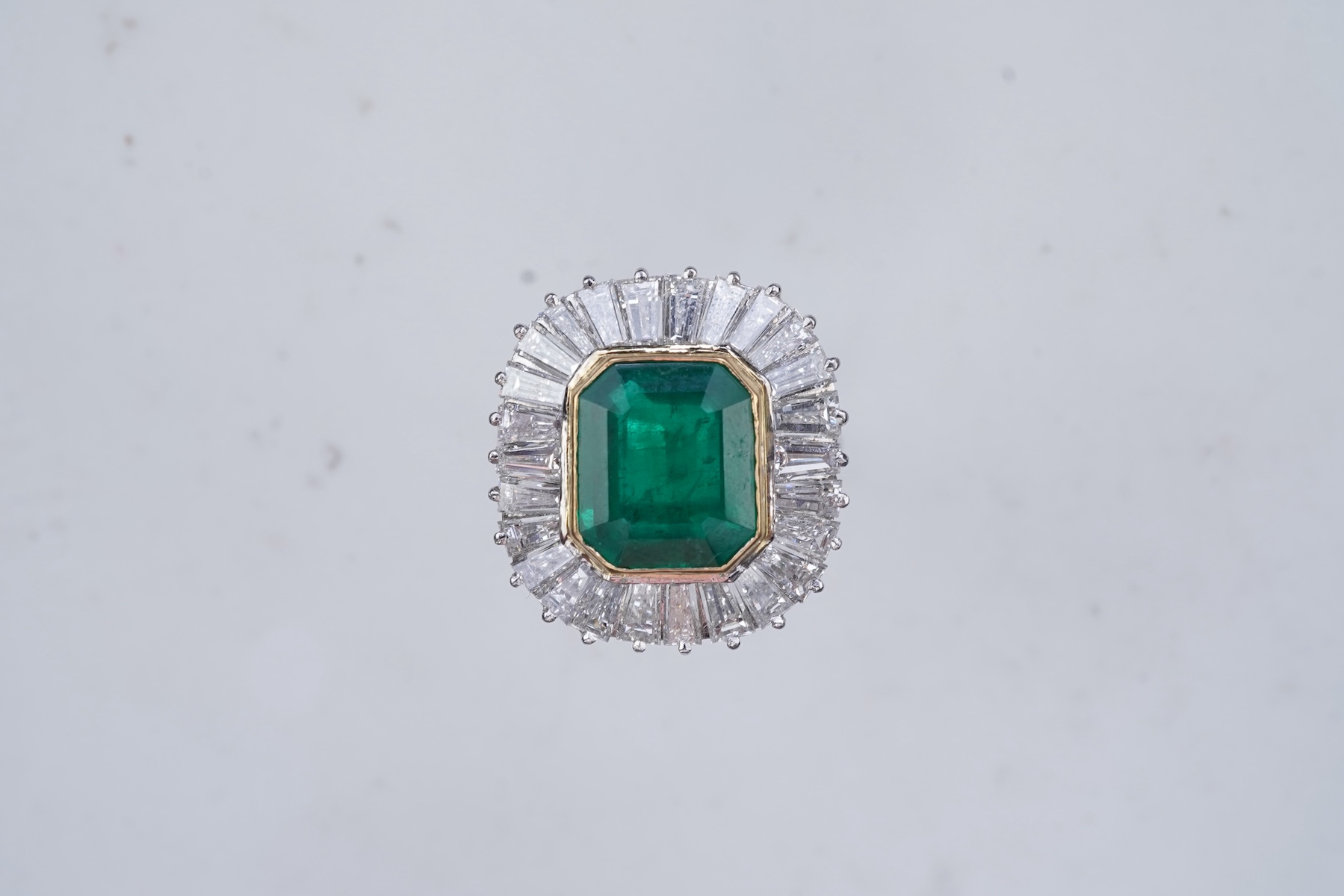An emerald and diamond ring